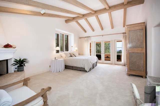 a dining room with furniture a chandelier and wooden floor