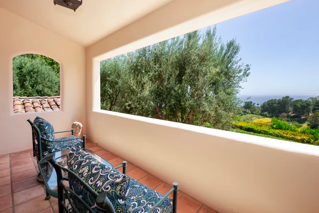 a spacious bedroom with a bed and wooden floor