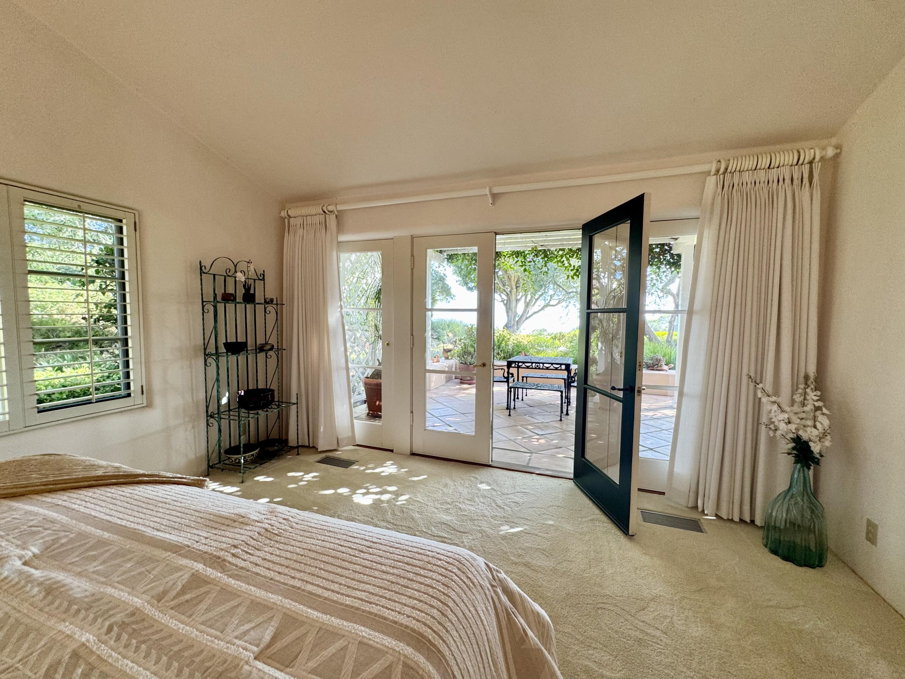 2240 Ortega Ranch Road Summerland, CA 93067 - Photo 42 of 87 a bedroom with a large bed and a large window