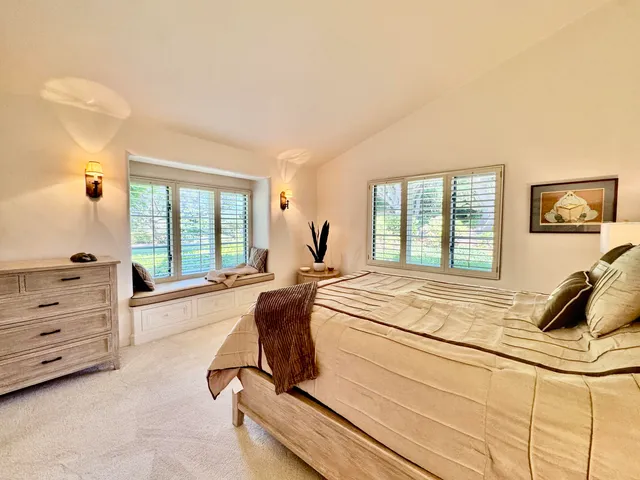 a backyard of a house with a yard and outdoor seating