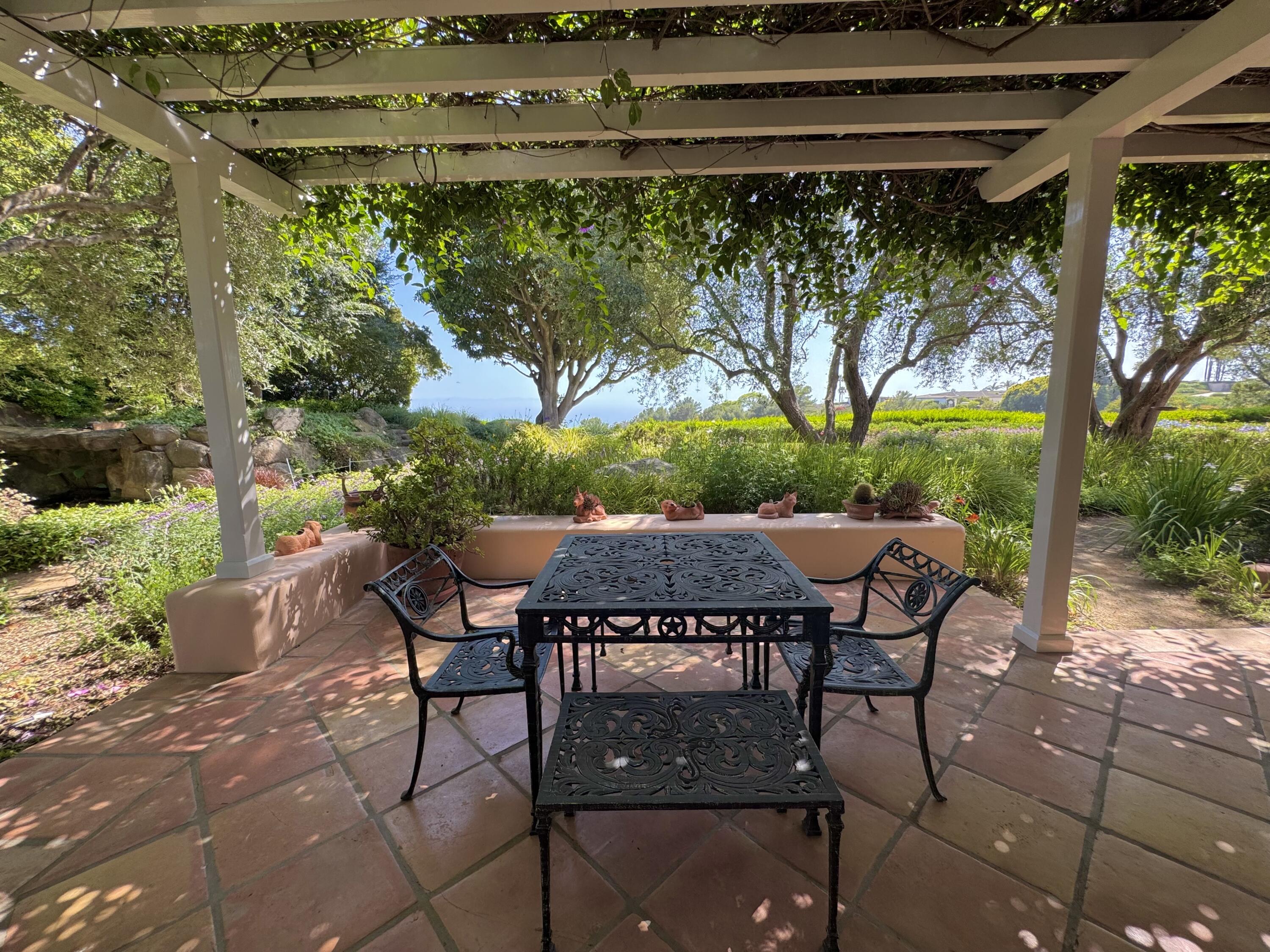 2240 Ortega Ranch Road Summerland, CA 93067 - Photo 76 of 87 a patio with table and chairs and potted plants