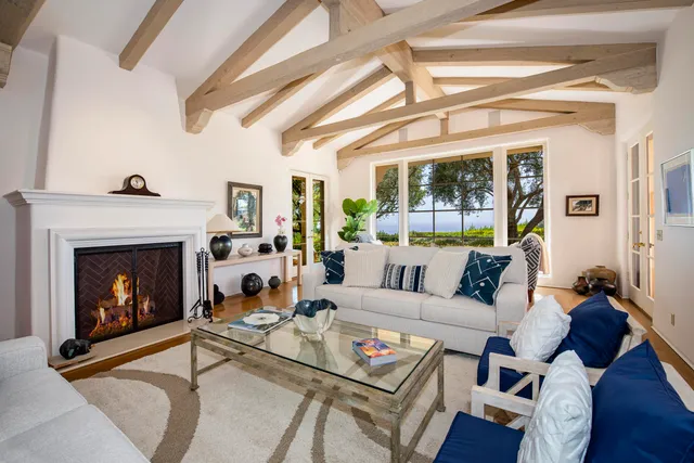 a living room with patio furniture and a large window