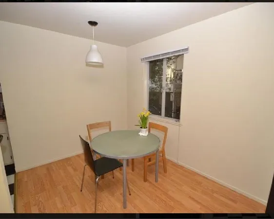 a dining room with furniture and wooden floor