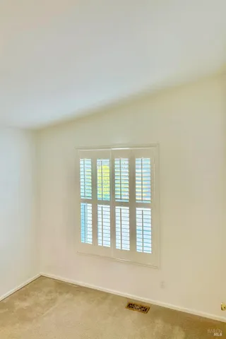 an empty room with a empty space and windows