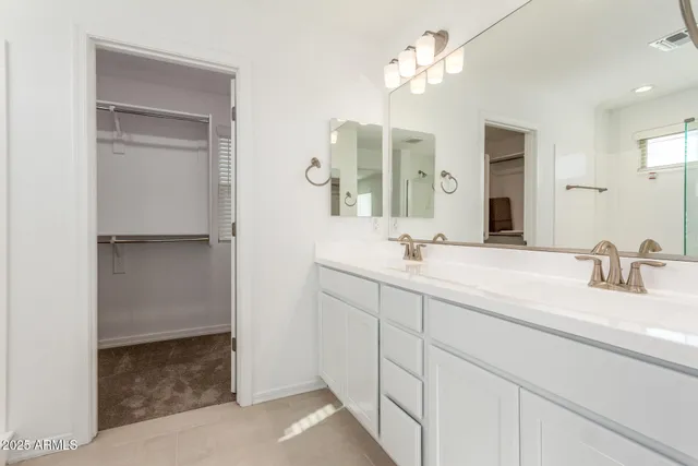 a bathroom with a double vanity sink and a mirror