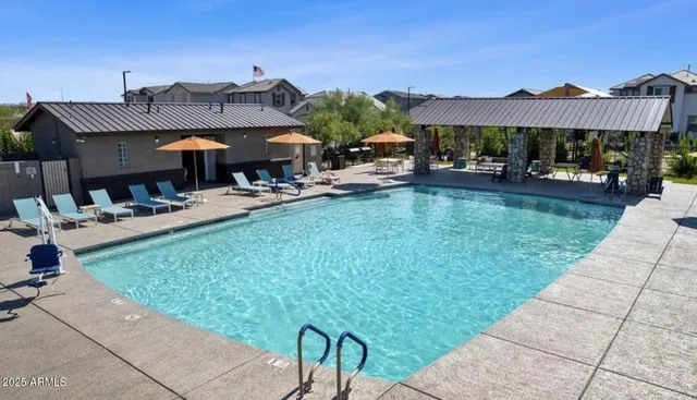 a view of a patio with table and chairs under an umbrella