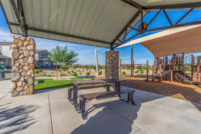 a building outdoor space with patio furniture and potted plants