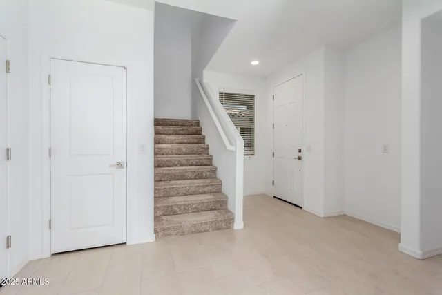 a view of an empty room with stairs
