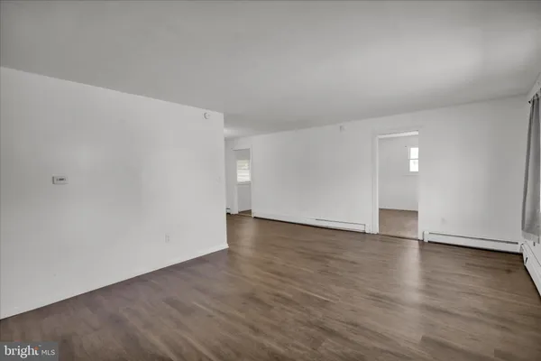 a view of an empty room and wooden floor