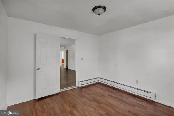 a view of a room with wooden floor