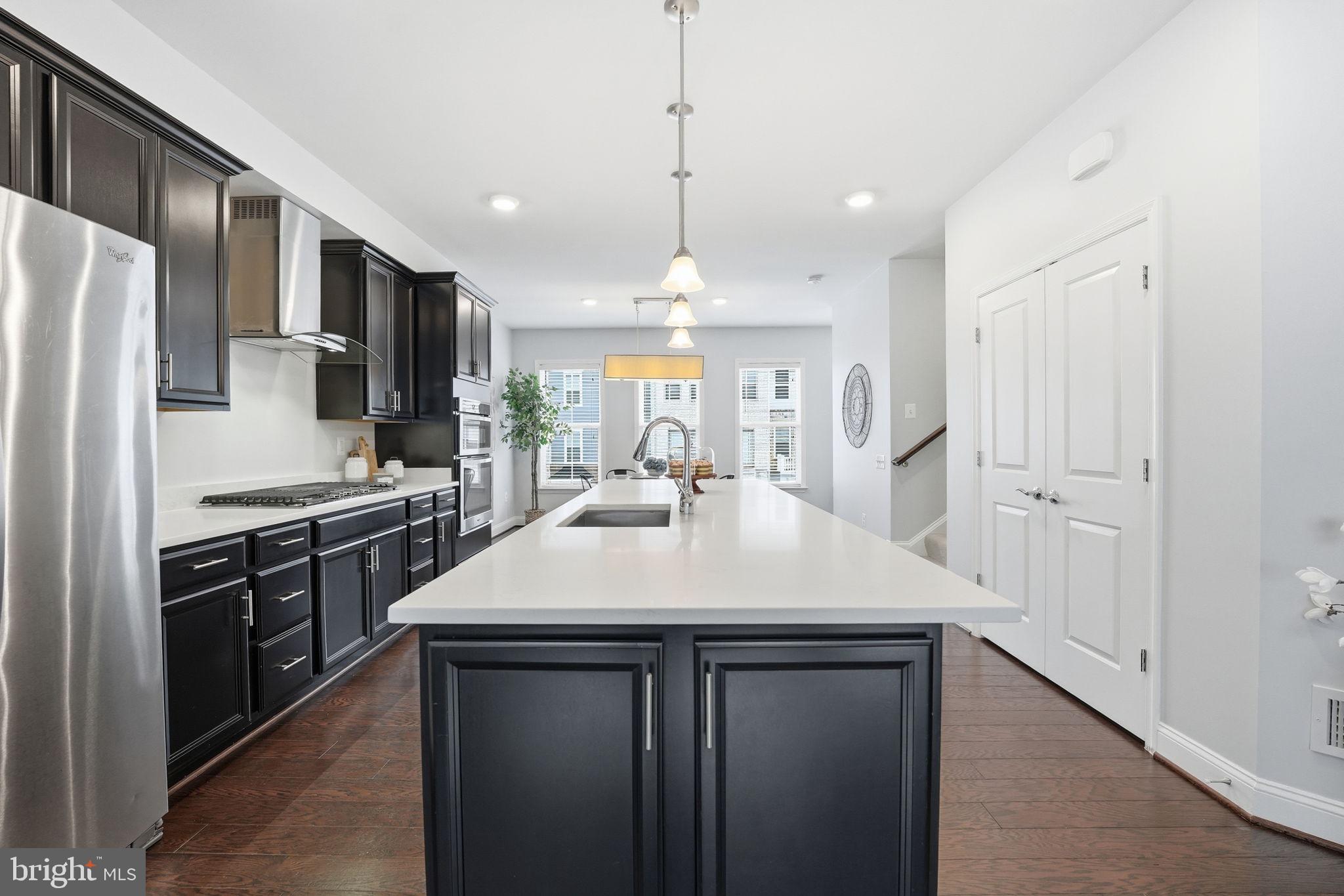 17354 Redshank Road Dumfries, VA 22026 - Photo 11 of 65 a kitchen with kitchen island a sink stainless steel appliances and window