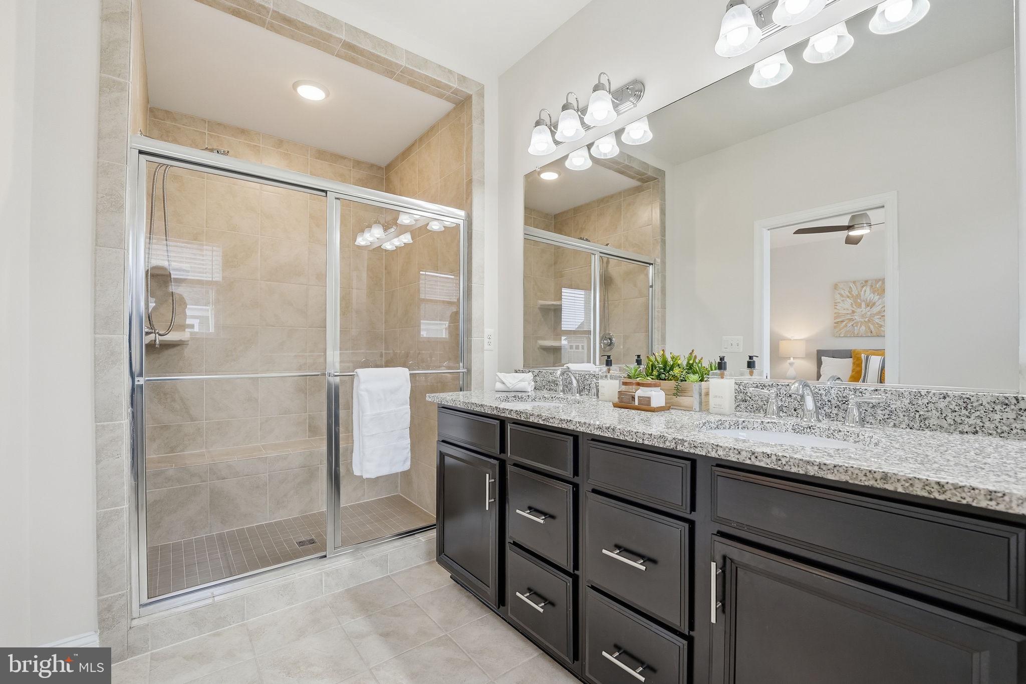 17354 Redshank Road Dumfries, VA 22026 - Photo 25 of 65 a bathroom with a granite countertop shower sink and mirror