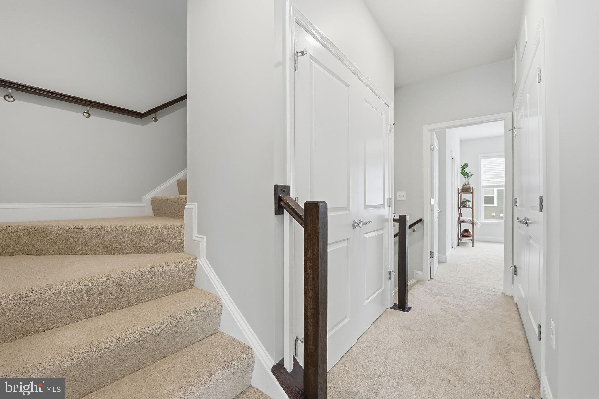 17354 Redshank Road Dumfries, VA 22026 - Photo 33 of 65 a view of a hallway with white walls and stairs