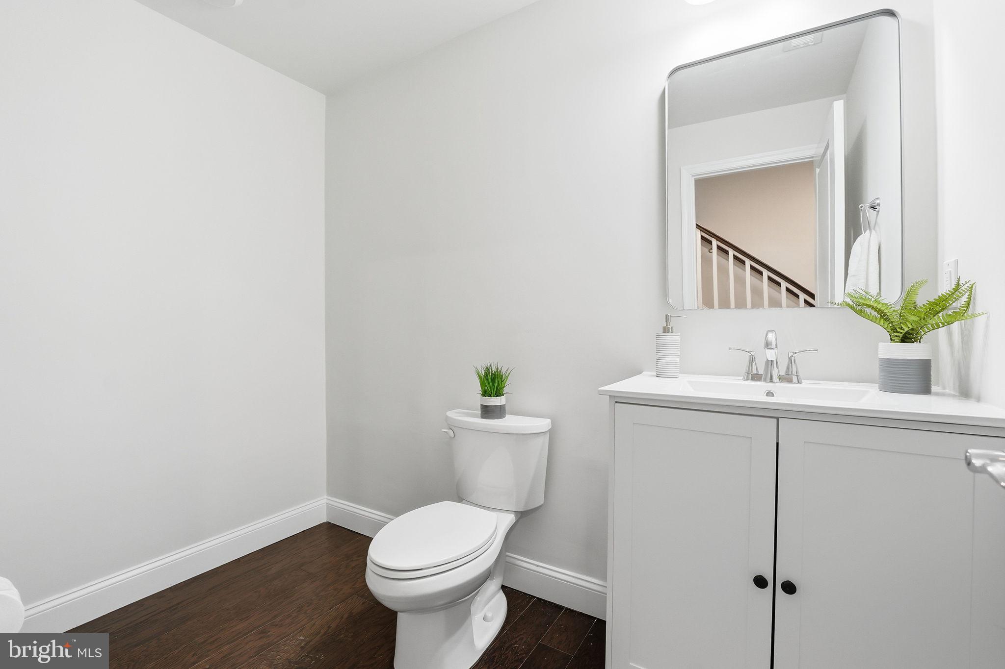 17354 Redshank Road Dumfries, VA 22026 - Photo 4 of 65 a bathroom with a sink mirror and toilet