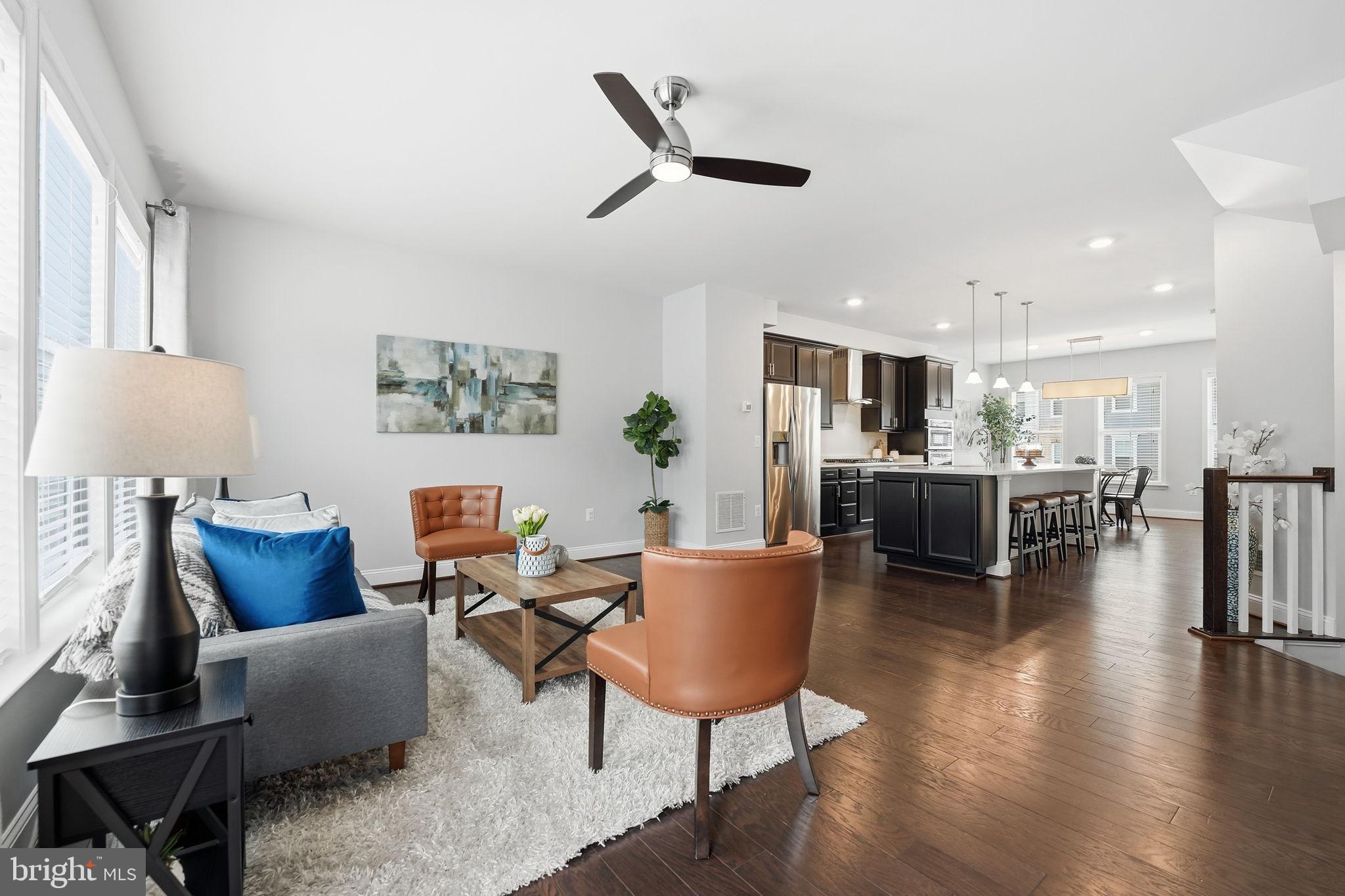 17354 Redshank Road Dumfries, VA 22026 - Photo 7 of 65 a living room with furniture or kitchen and a table