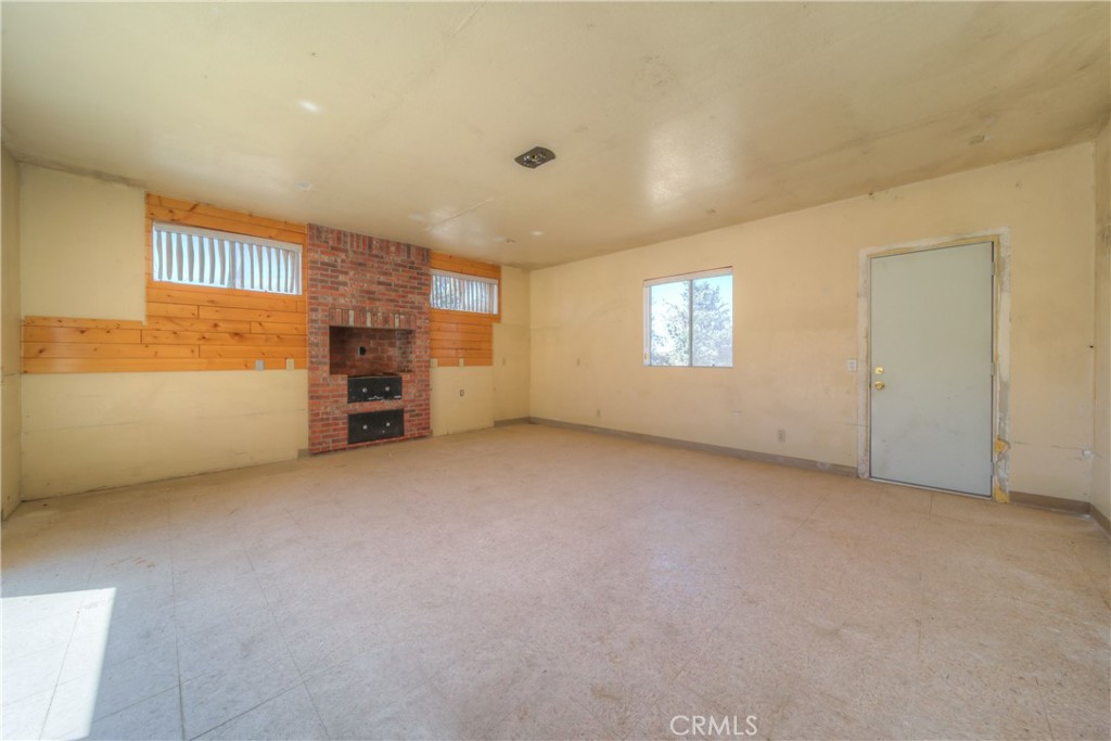 55743 Mitchell Road Anza, CA 92539 - Photo 11 of 46 an empty room with a window and fireplace