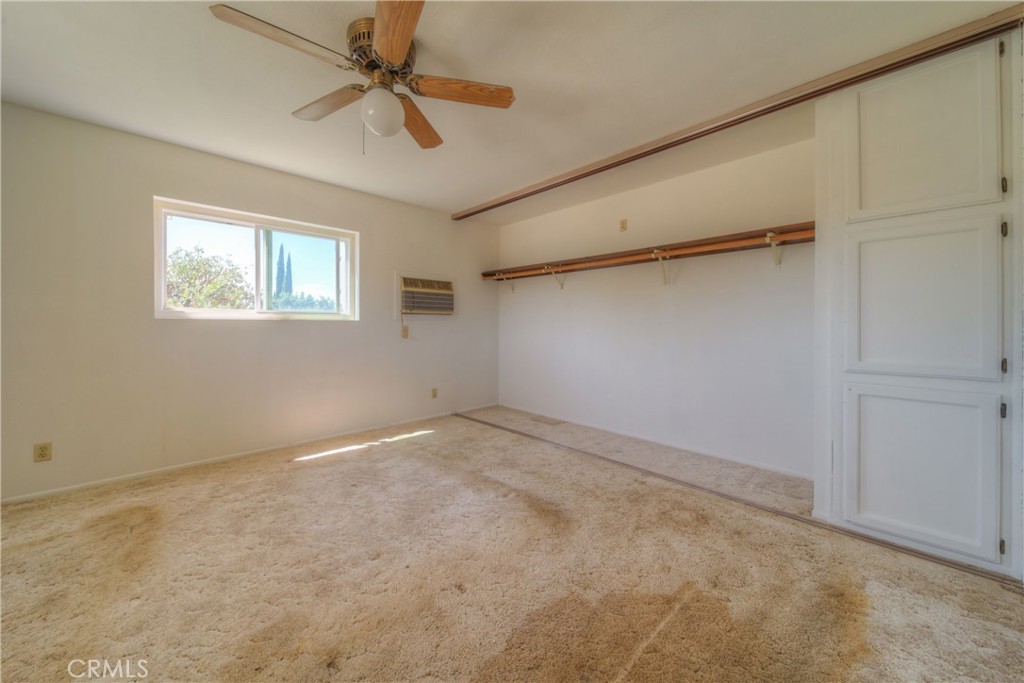 55743 Mitchell Road Anza, CA 92539 - Photo 13 of 46 an empty room with a ceiling fan and a window