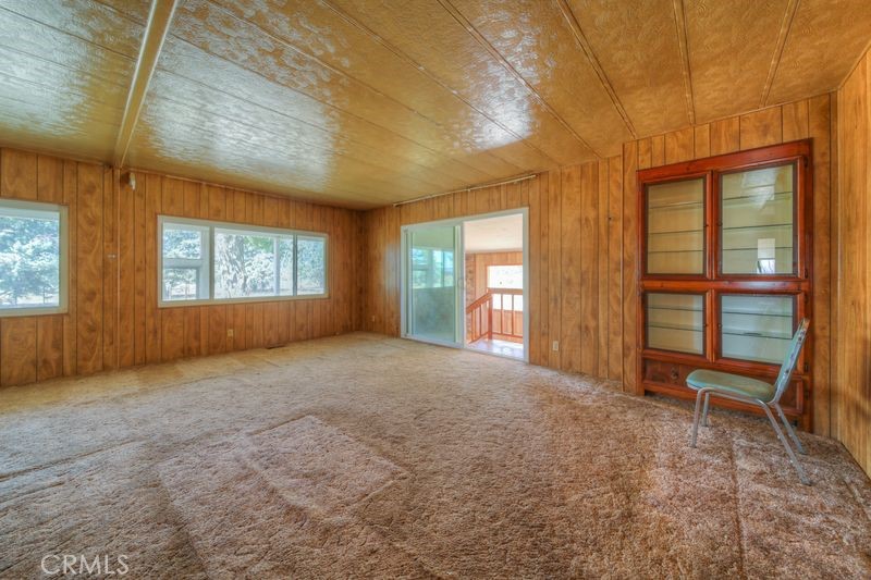 55743 Mitchell Road Anza, CA 92539 - Photo 16 of 46 a view of an empty room with a fireplace and a window