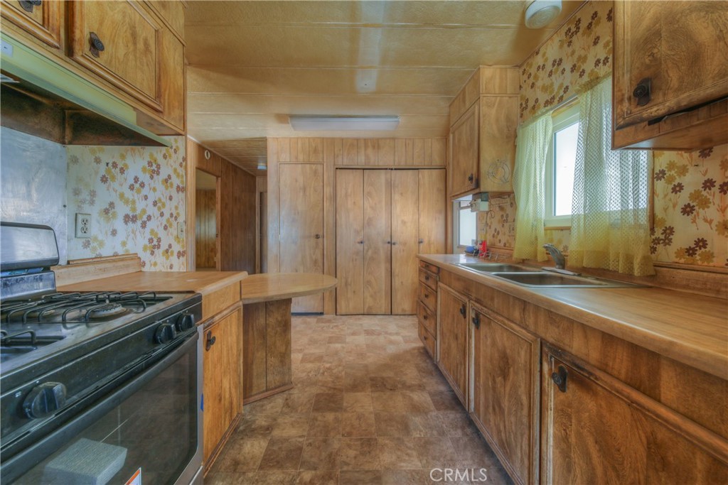 55743 Mitchell Road Anza, CA 92539 - Photo 18 of 46 a kitchen with stainless steel appliances granite countertop a stove and a sink