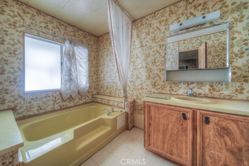 55743 Mitchell Road Anza, CA 92539 - Photo 24 of 46 a bathroom with a granite countertop bathtub sink and mirror