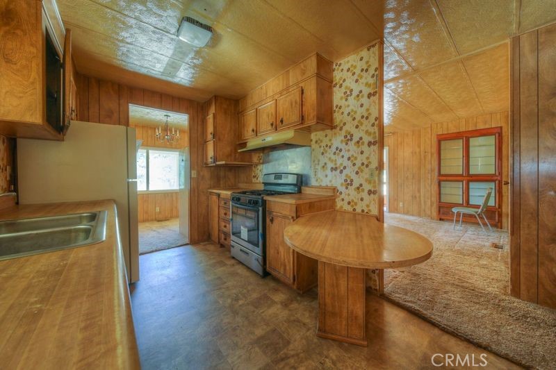 55743 Mitchell Road Anza, CA 92539 - Photo 30 of 46 a kitchen with stainless steel appliances granite countertop a sink a stove and a wooden floors