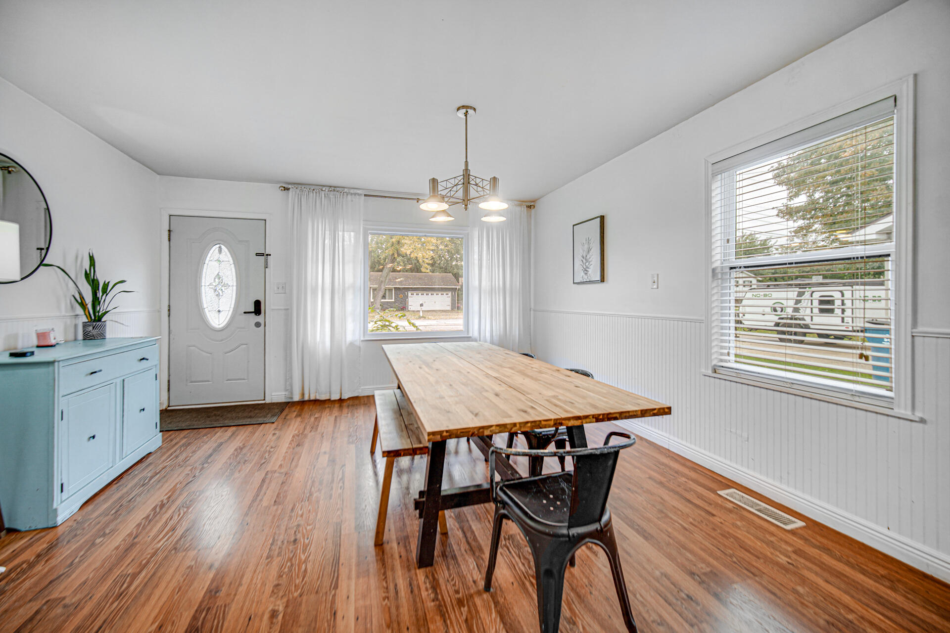 2009 West Porter Avenue Chesterton, IN 46304 - Photo 12 of 21 a dining room with wooden floor a chandelier a wooden table and chairs
