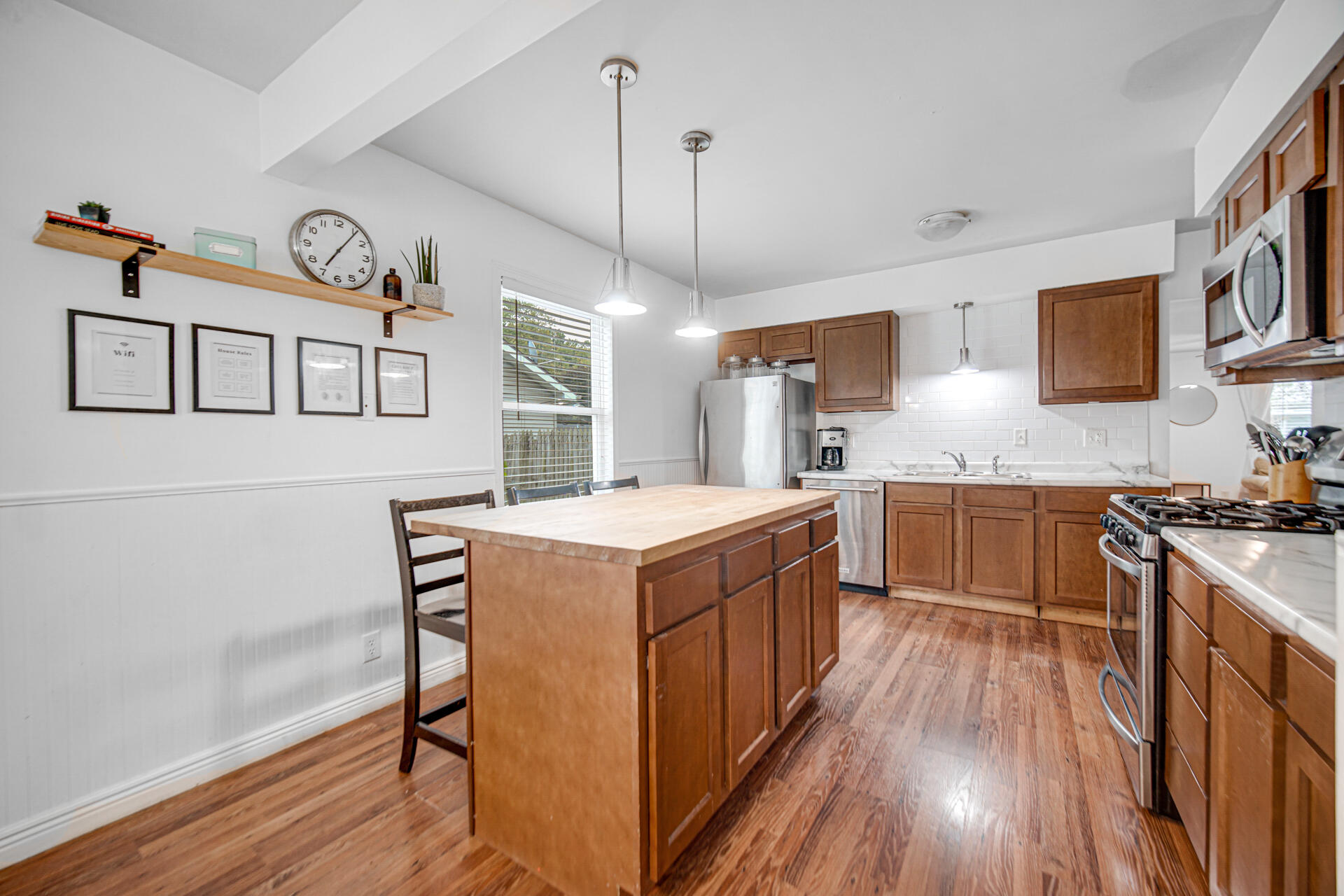 2009 West Porter Avenue Chesterton, IN 46304 - Photo 6 of 21 a kitchen with stainless steel appliances granite countertop a stove a sink dishwasher and a refrigerator with wooden floor