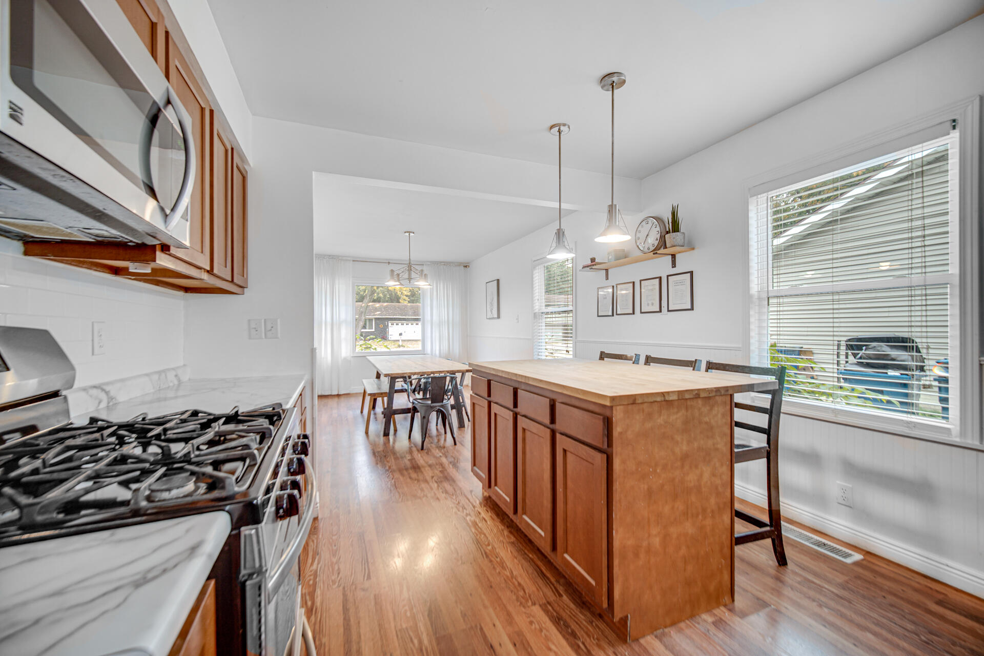 2009 West Porter Avenue Chesterton, IN 46304 - Photo 9 of 21 a kitchen with stainless steel appliances granite countertop a stove top oven a sink a dining table and chairs with wooden floor