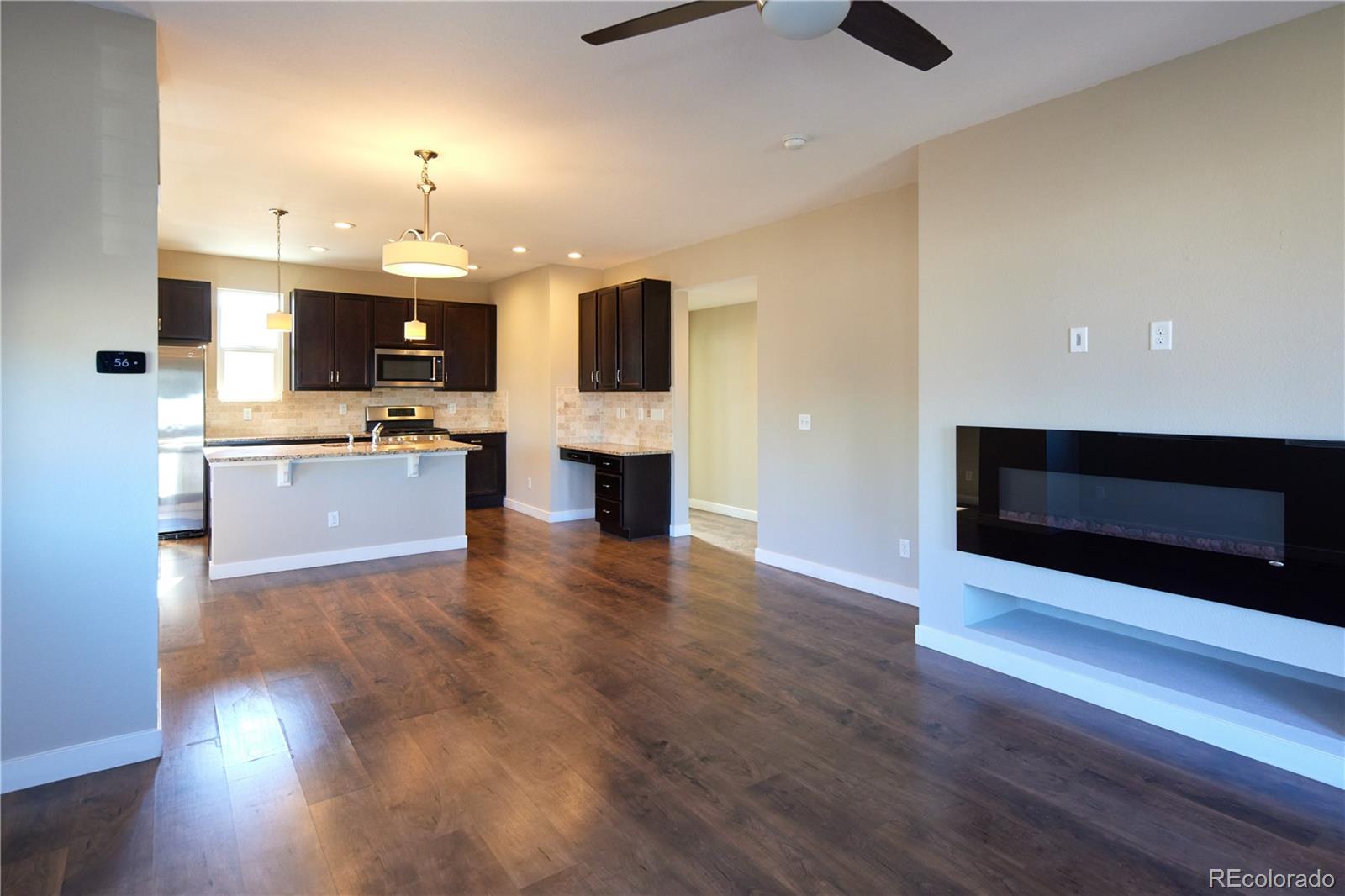 11225 Colony Row Broomfield, CO 80021 - Photo 12 of 31 a view of kitchen with sink microwave and stove