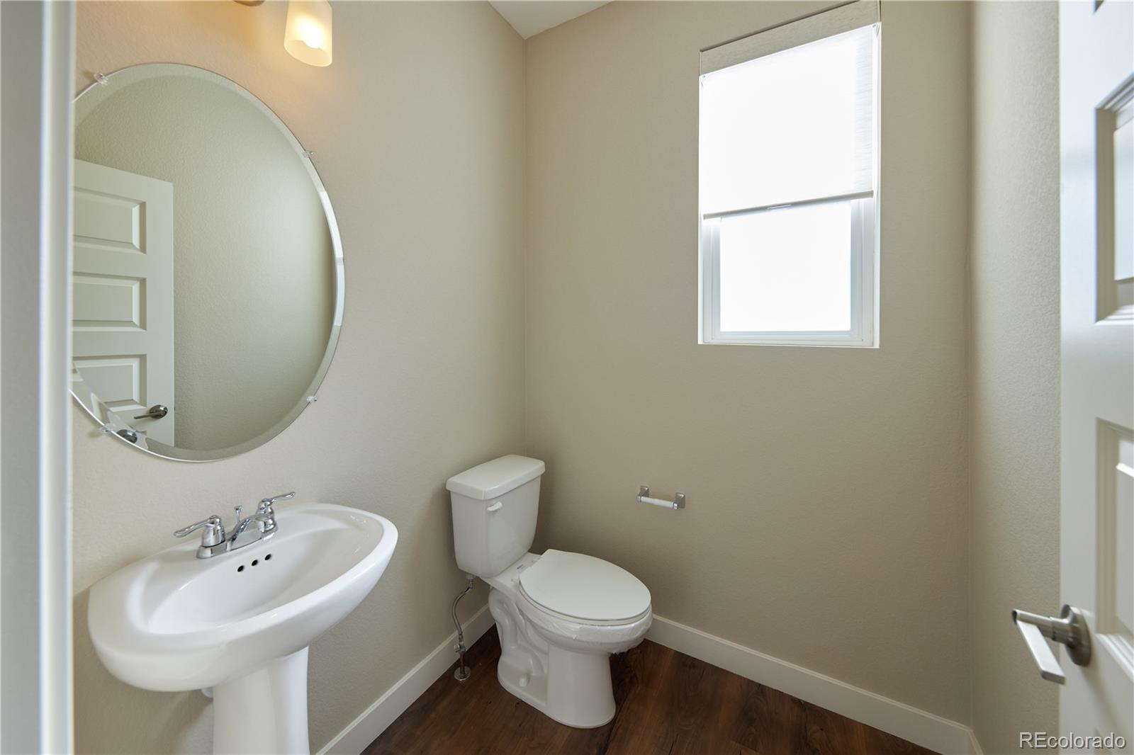 11225 Colony Row Broomfield, CO 80021 - Photo 13 of 31 a bathroom with a sink a mirror and a toilet