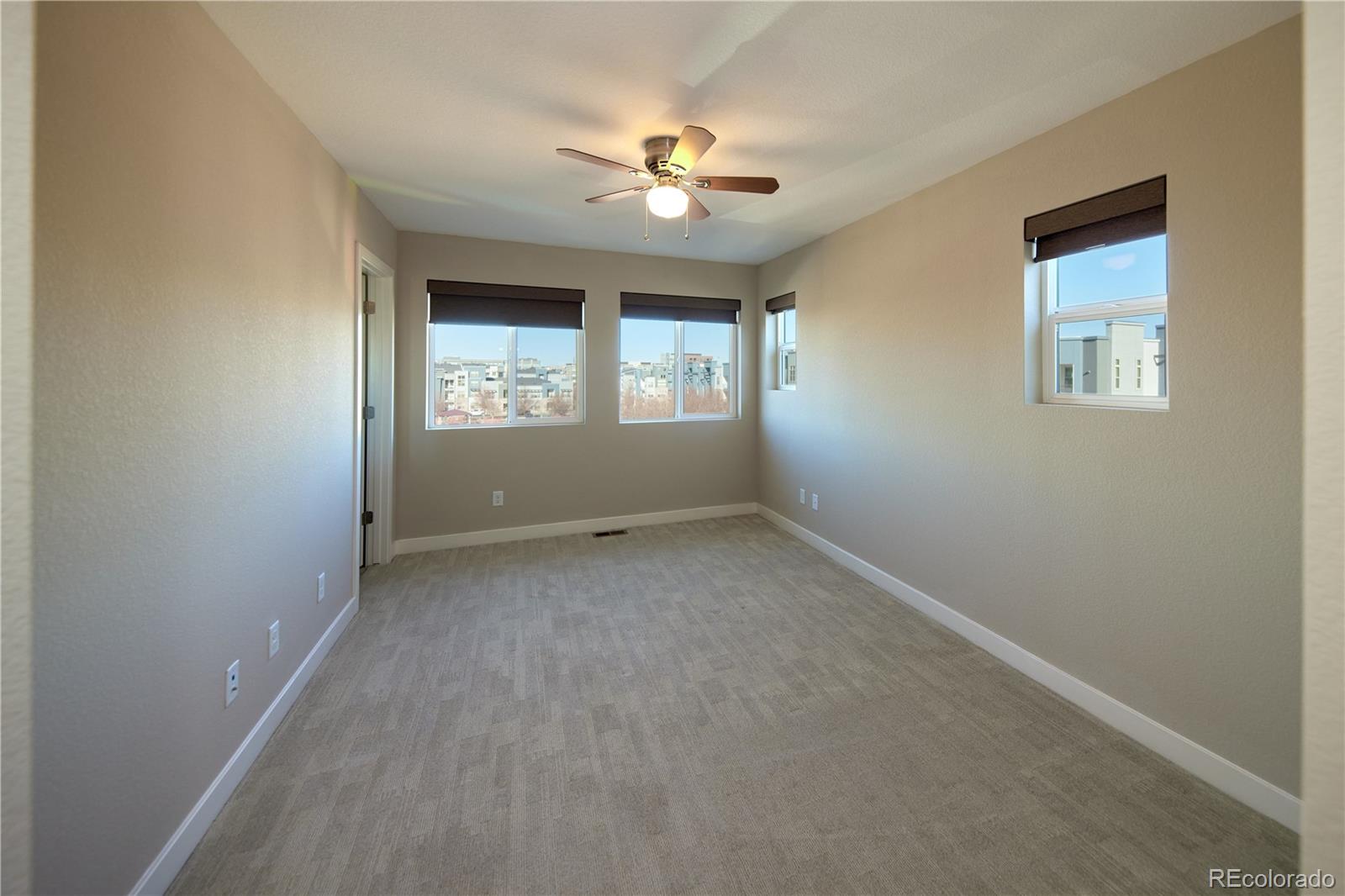 11225 Colony Row Broomfield, CO 80021 - Photo 18 of 31 an empty room with a window and a fan