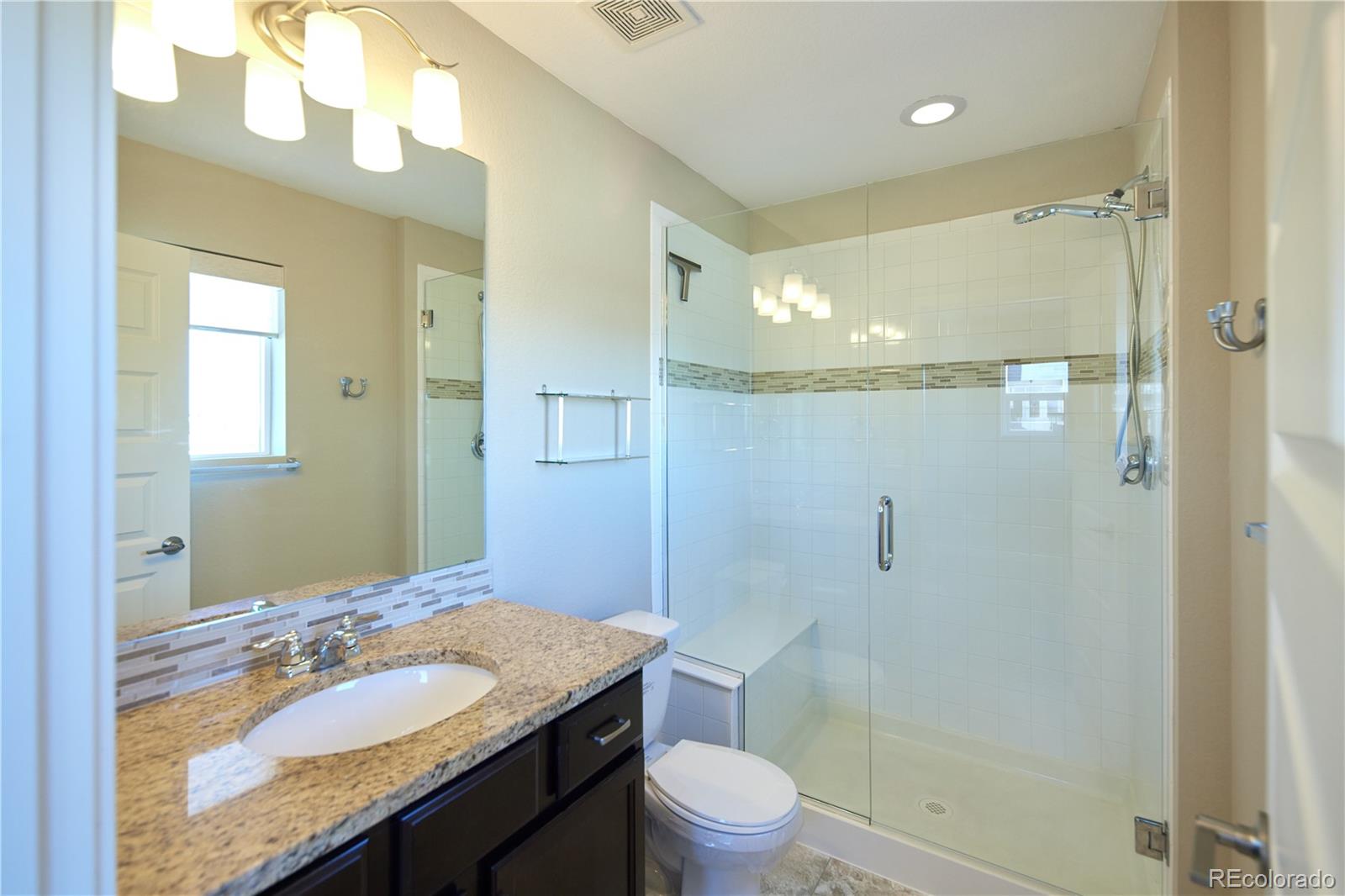 11225 Colony Row Broomfield, CO 80021 - Photo 21 of 31 a bathroom with a sink a toilet and shower