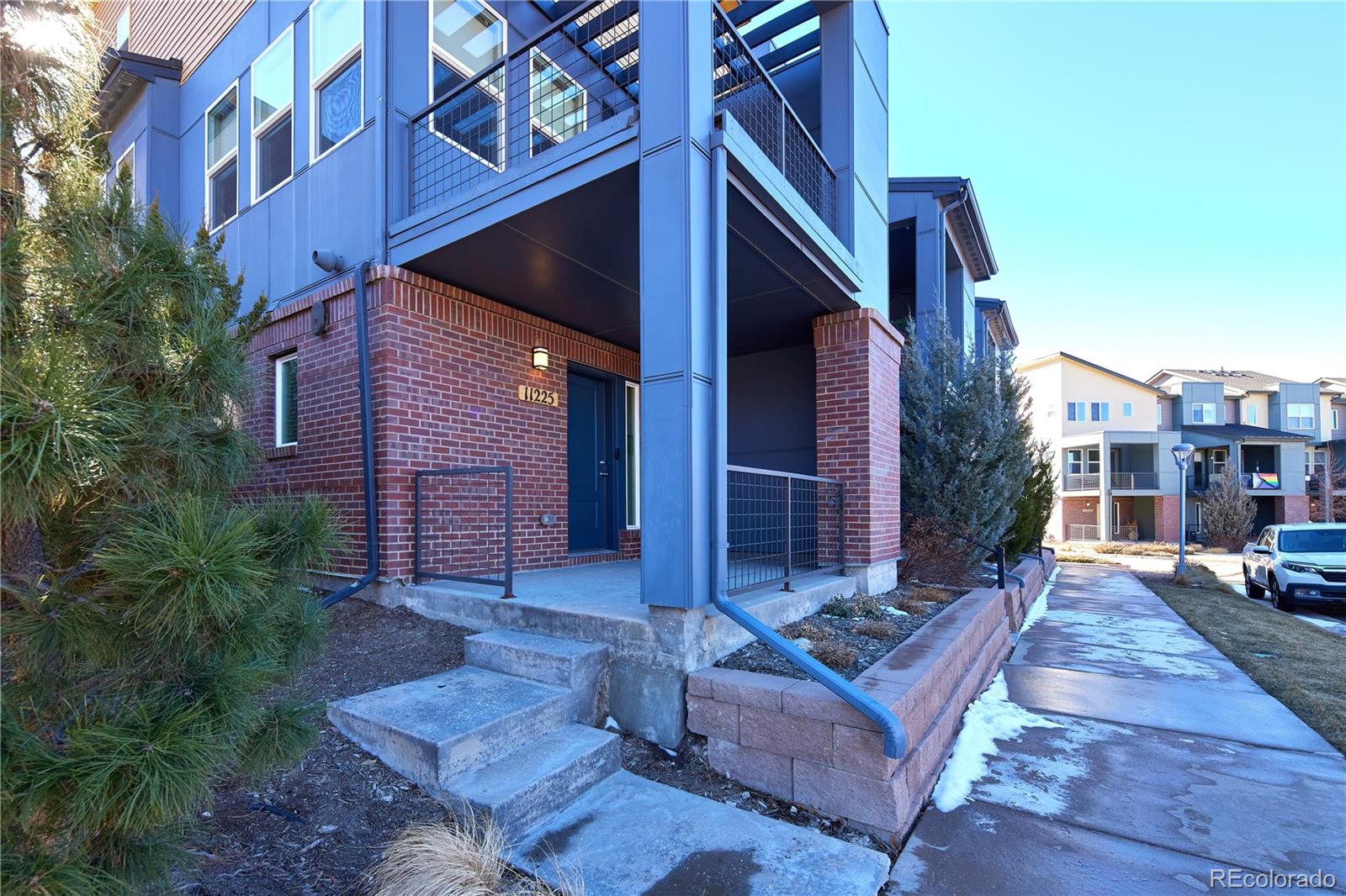11225 Colony Row Broomfield, CO 80021 - Photo 31 of 31 a view of brick building with a bench in front of building
