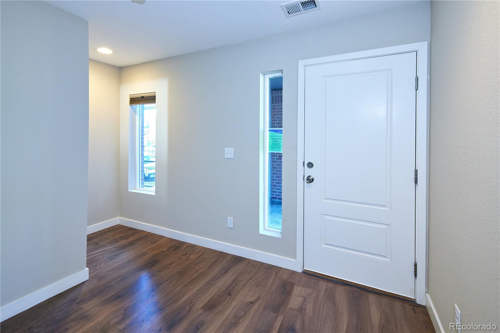 11225 Colony Row Broomfield, CO 80021 - Photo 5 of 31 an empty room with wooden floor and windows