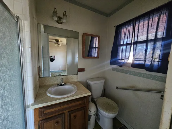a bathroom with a sink toilet and mirror