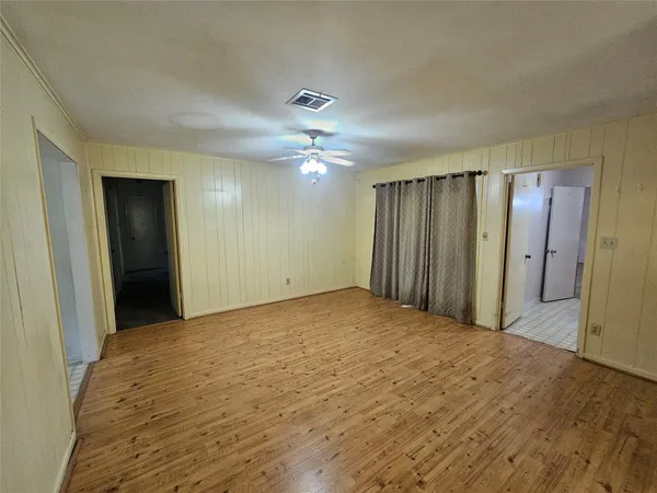 a view of kitchen with white cabinets and wooden floor