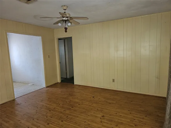 a view of a hallway with a chandelier fan