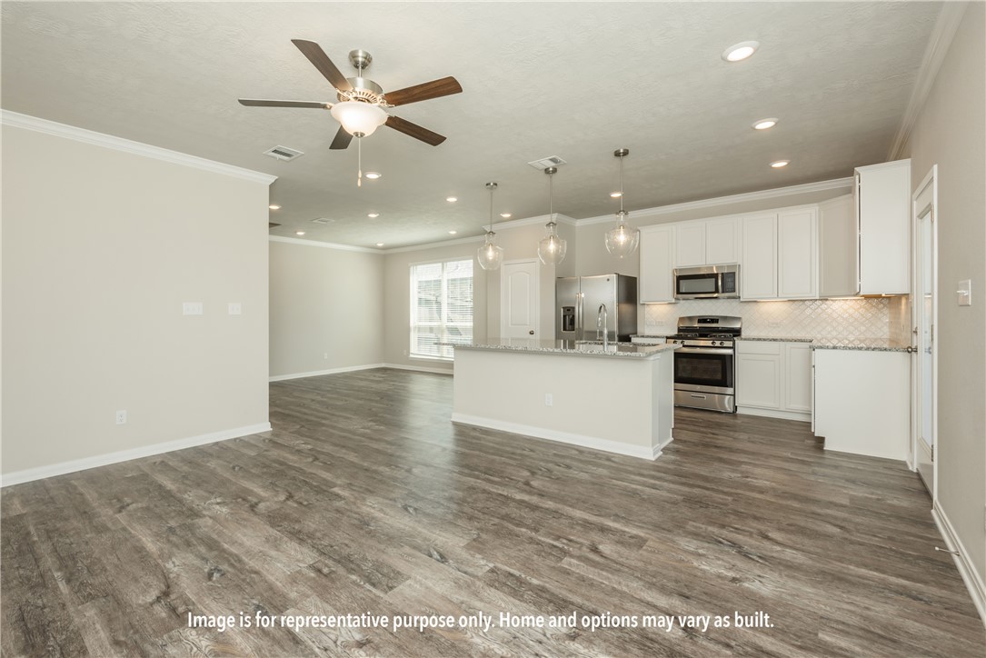 4752 Holm Oak Road Bryan, TX 77845 - Photo 9 of 9 a view of kitchen with kitchen island white cabinets and refrigerator