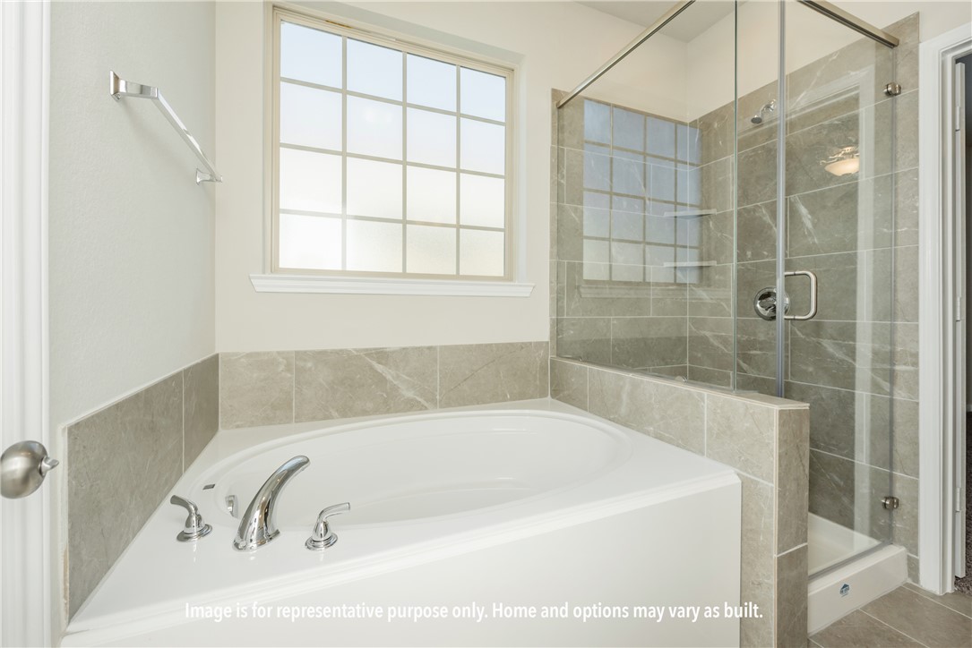4752 Holm Oak Road Bryan, TX 77845 - Photo 4 of 8 a bathroom with a bathtub and shower