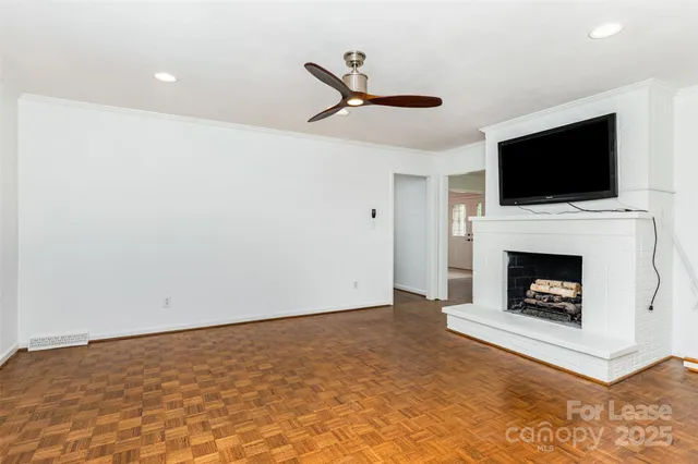 a living room with a fireplace and a flat screen tv