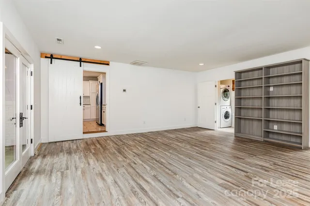 a view of empty room with wooden floor and cabinet
