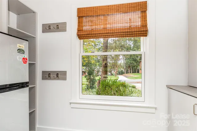 a view of a kitchen with a refrigerator and window