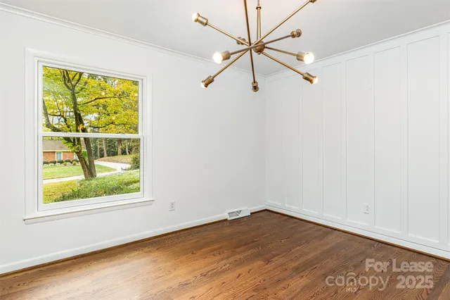 an empty room with a window and a ceiling fan
