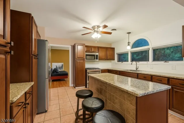 a view of a livingroom with workspace and a window