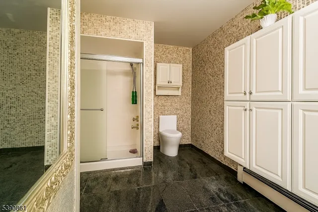 a kitchen with white cabinets and sink