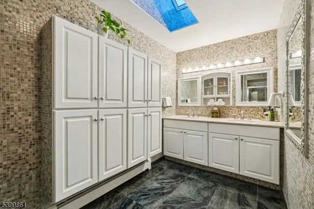 a bathroom with a double vanity sink and mirror