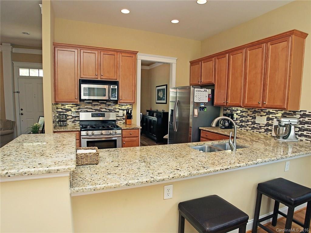 1865 2nd Baxter Crossing Fort Mill, SC 29708 - Photo 12 of 24 a kitchen with stainless steel appliances granite countertop a sink refrigerator and cabinets
