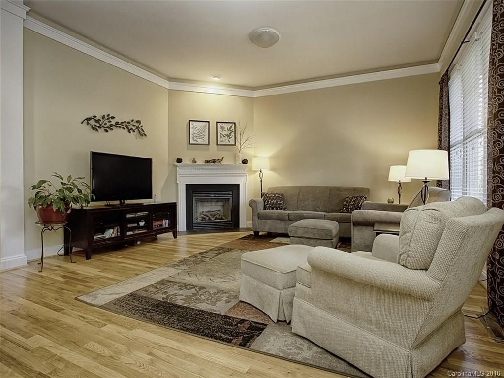 1865 2nd Baxter Crossing Fort Mill, SC 29708 - Photo 6 of 24 a living room with furniture a flat screen tv and a fireplace