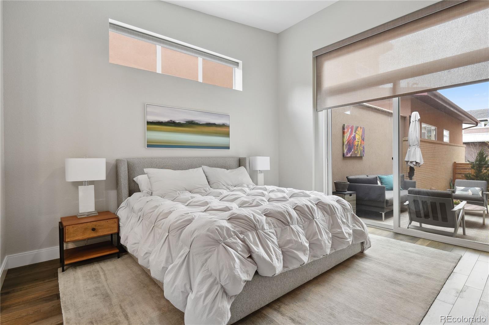 76 Niagara Street Denver, CO 80230 - Photo 13 of 44 a bedroom with a bed and wooden floor