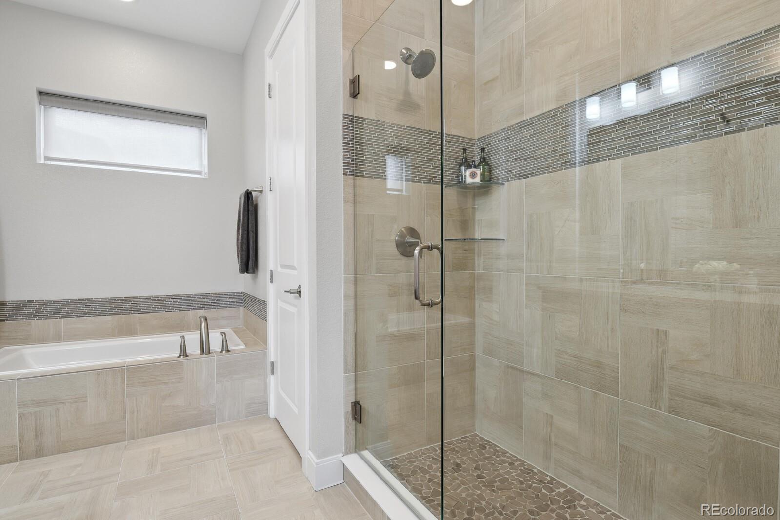 76 Niagara Street Denver, CO 80230 - Photo 16 of 44 a bathroom with a shower and a bath tub